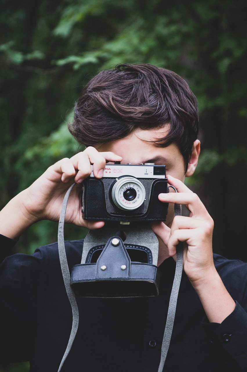 “Photographer holding camera during outdoor photoshoot”