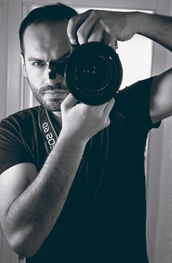 Portrait of a photographer holding camera – Pixel Poetry Photography Team